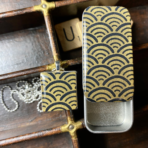 A Scrabble Tile Pendant and Teeny Tiny Tin Ocean Black